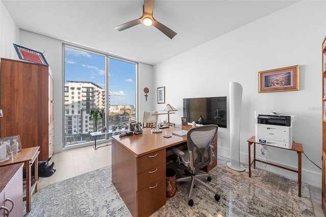 office area with floor to ceiling windows, light wood-type flooring, and ceiling fan