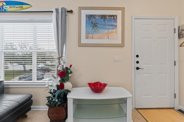 doorway with light tile patterned flooring