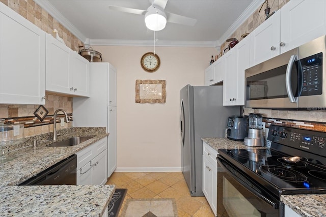 kitchen featuring light stone counters, black appliances, sink, and white cabinets