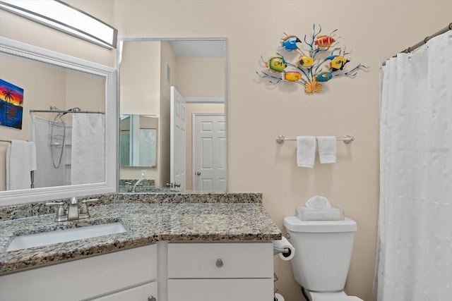 bathroom featuring vanity, curtained shower, and toilet