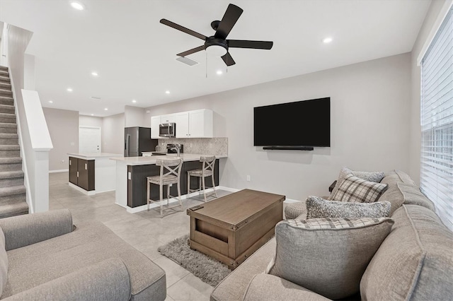 living room featuring ceiling fan and light tile patterned flooring