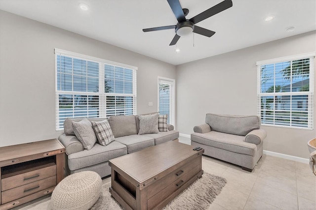 living room featuring a wealth of natural light, ceiling fan, and light tile patterned flooring