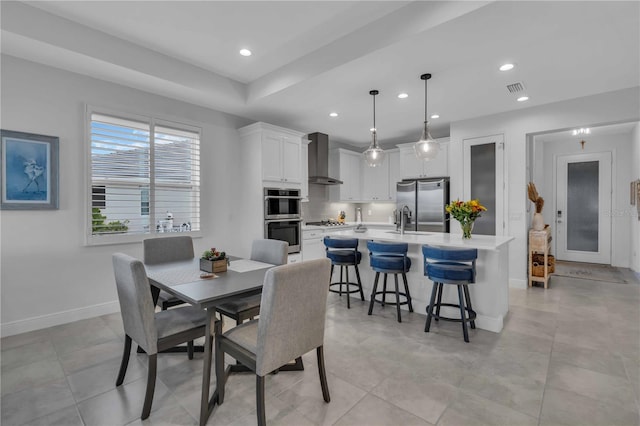 dining area with sink and light tile patterned floors