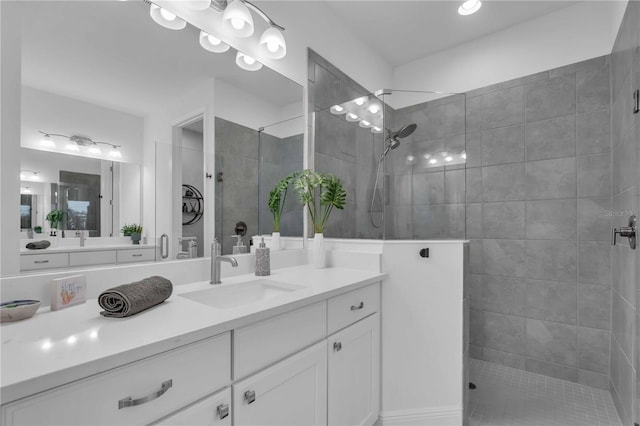 bathroom featuring vanity and a shower with shower door