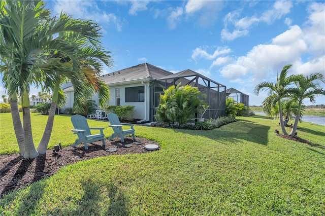 view of yard featuring a lanai and a water view