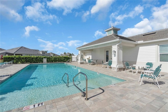 view of swimming pool with a patio