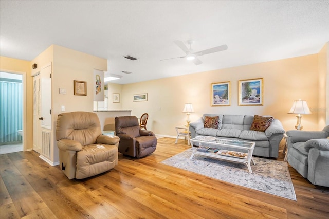 living room featuring ceiling fan and wood-type flooring