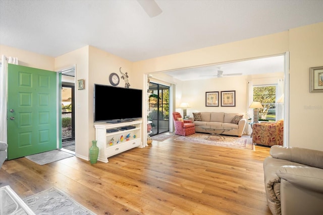 living room with light hardwood / wood-style floors, plenty of natural light, and ceiling fan