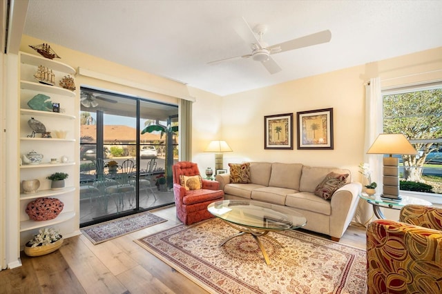 living room featuring ceiling fan and light wood-type flooring