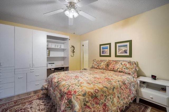 bedroom featuring ceiling fan, a textured ceiling, and dark hardwood / wood-style floors