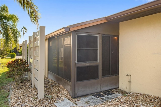 view of side of home featuring a sunroom