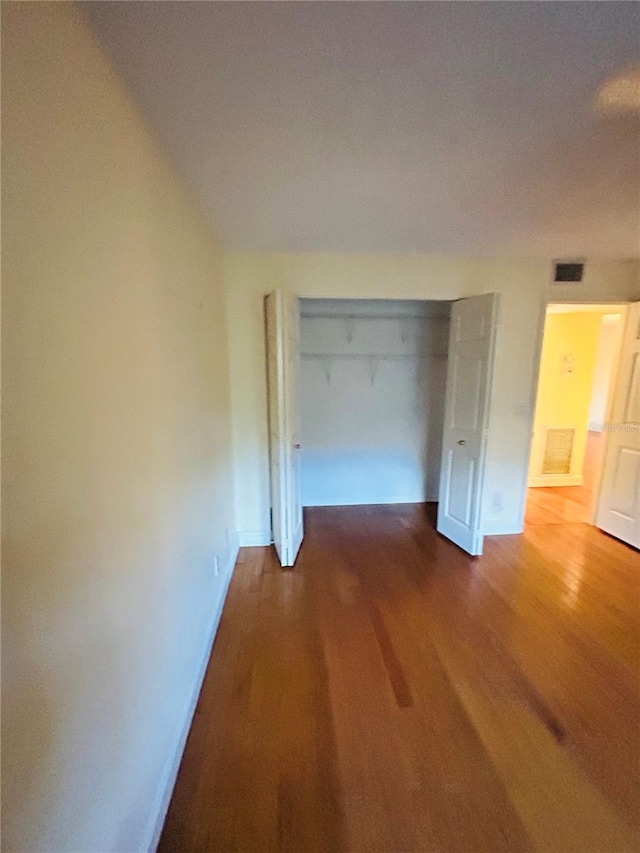 corridor featuring dark hardwood / wood-style flooring