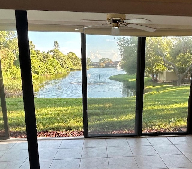 doorway with a water view and light tile patterned flooring