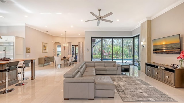 living area featuring ornamental molding, arched walkways, ceiling fan, and recessed lighting