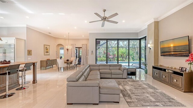 9291 Swaying Branch Rd, Sarasota, FL 34241 - living area with crown molding, recessed lighting, ceiling fan, arched walkways, and light tile patterned floors