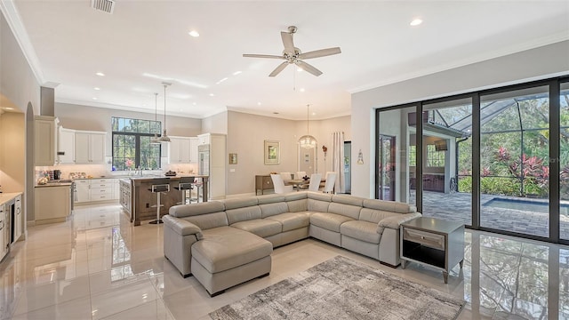 9291 Swaying Branch Rd, Sarasota, FL 34241 - living room with plenty of natural light, light tile patterned floors, ceiling fan, recessed lighting, and crown molding