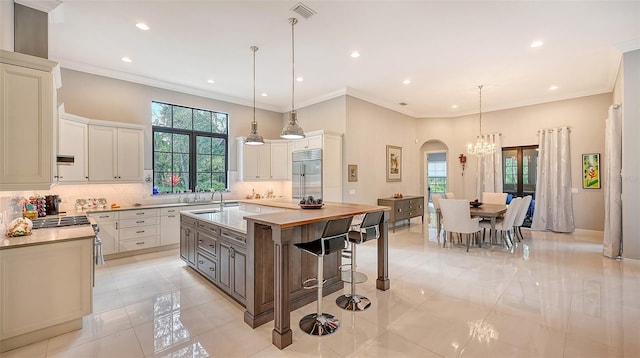 9291 Swaying Branch Rd, Sarasota, FL 34241 - kitchen with stainless steel appliances, arched walkways, a sink, backsplash, and light countertops