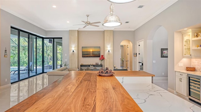 kitchen featuring beverage cooler, visible vents, white cabinets, open floor plan, and light stone countertops