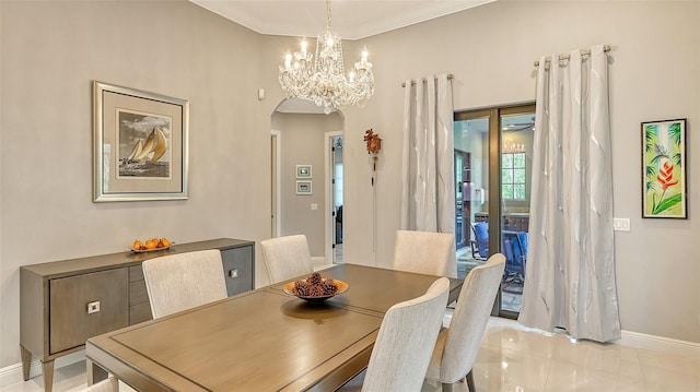 tiled dining room with ceiling fan and crown molding