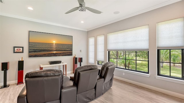 cinema room featuring ornamental molding, light wood-type flooring, baseboards, and recessed lighting