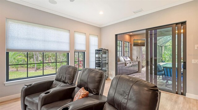 9291 Swaying Branch Rd, Sarasota, FL 34241 - living area featuring baseboards, wood finished floors, plenty of natural light, ornamental molding, and recessed lighting