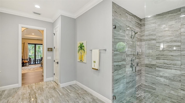 bathroom featuring an enclosed shower, hardwood / wood-style flooring, and crown molding