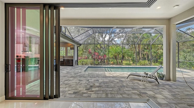 outdoor pool with glass enclosure and a patio area