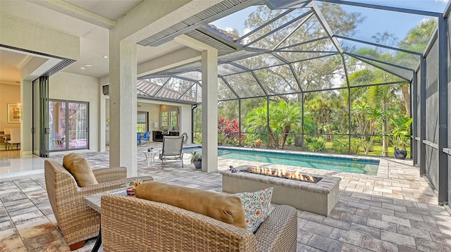 view of patio / terrace featuring glass enclosure, an outdoor living space with a fire pit, and an outdoor pool