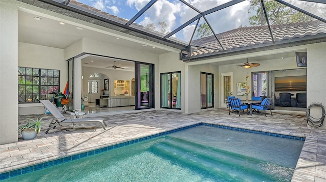 pool with a patio area, ceiling fan, and outdoor dining area