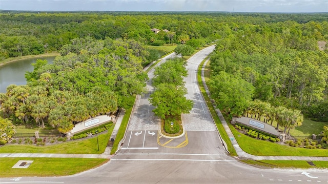 bird's eye view with a water view and a forest view