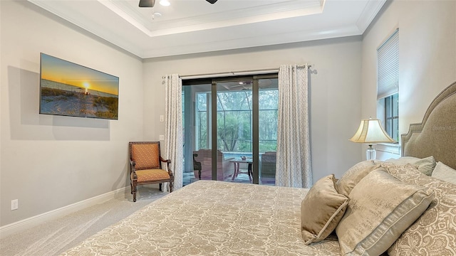 bedroom with access to outside, ornamental molding, a tray ceiling, and carpet floors