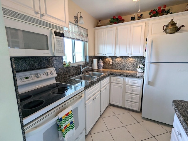 kitchen featuring backsplash, sink, white cabinets, and white appliances