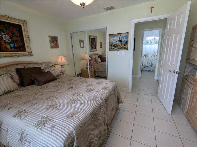 tiled bedroom with a closet