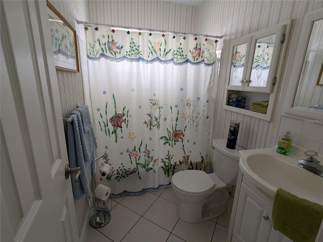 bathroom with vanity, toilet, and tile patterned flooring