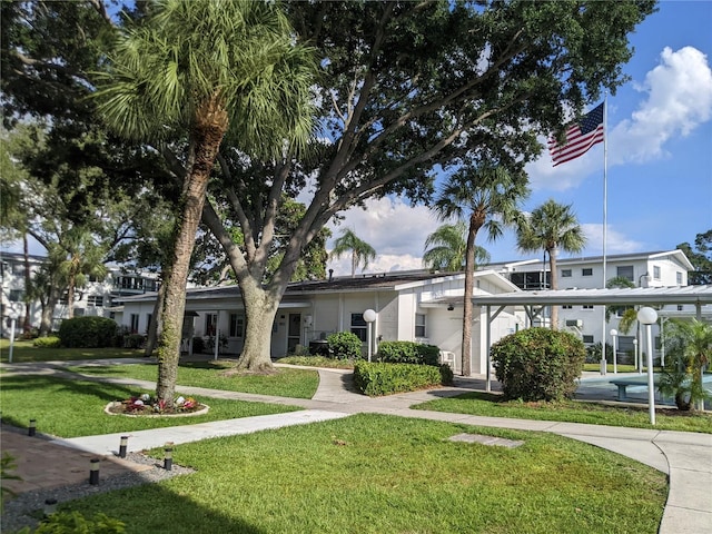 view of front of home featuring a front lawn and a carport