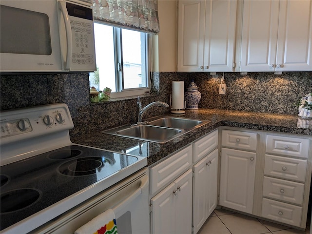 kitchen featuring white appliances, sink, backsplash, white cabinetry, and light tile patterned floors