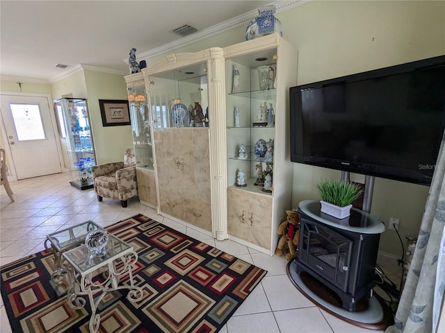 tiled living room with ornamental molding and a wood stove