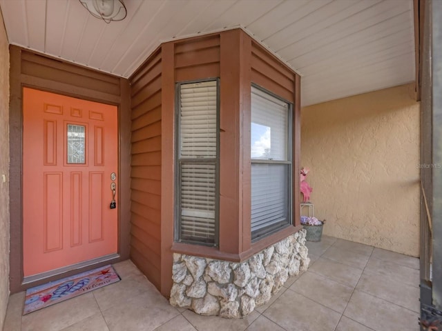 view of exterior entry with a porch