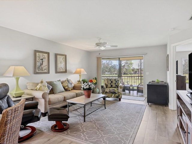 living room featuring ceiling fan and light wood-type flooring