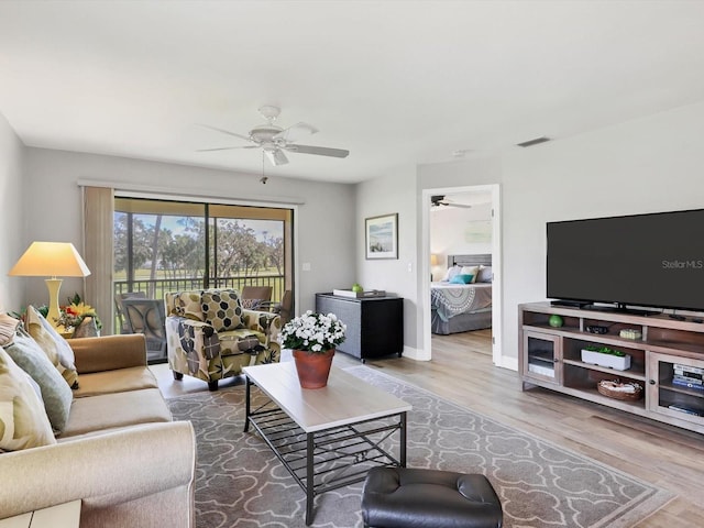 living room featuring hardwood / wood-style flooring and ceiling fan