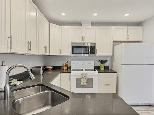 kitchen with light hardwood / wood-style floors, sink, and white appliances