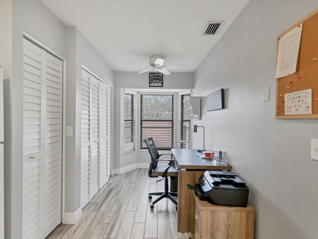 home office featuring light hardwood / wood-style floors and ceiling fan