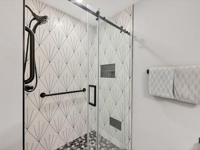 bathroom featuring a shower with shower door