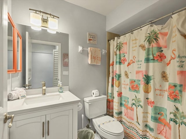 bathroom featuring vanity, curtained shower, and toilet