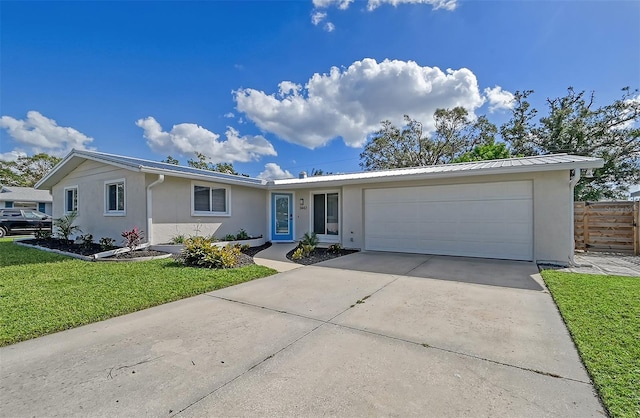 single story home with a garage and a front lawn