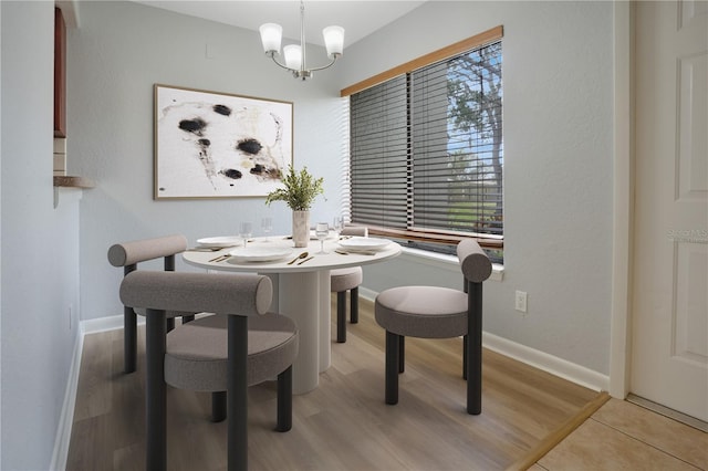 dining room featuring light hardwood / wood-style floors and a chandelier