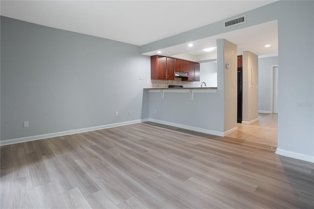 unfurnished living room with light hardwood / wood-style flooring