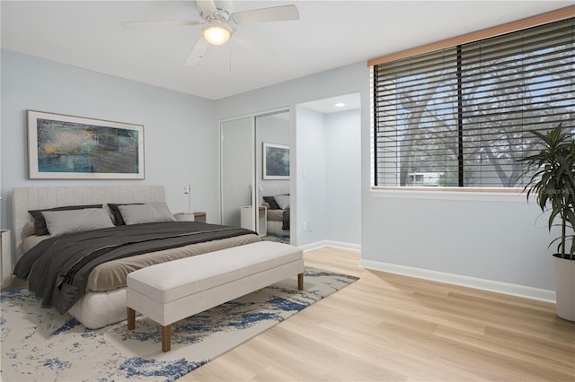 bedroom featuring light wood-type flooring, a closet, and ceiling fan