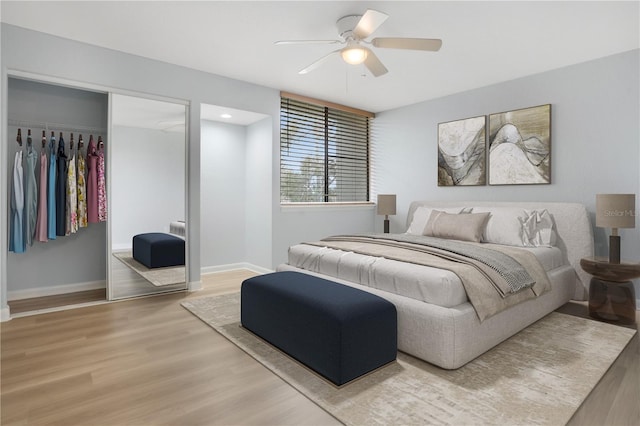 bedroom featuring hardwood / wood-style flooring, a closet, and ceiling fan