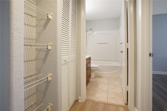 full bathroom featuring vanity, hardwood / wood-style flooring, toilet, and shower / bathtub combination